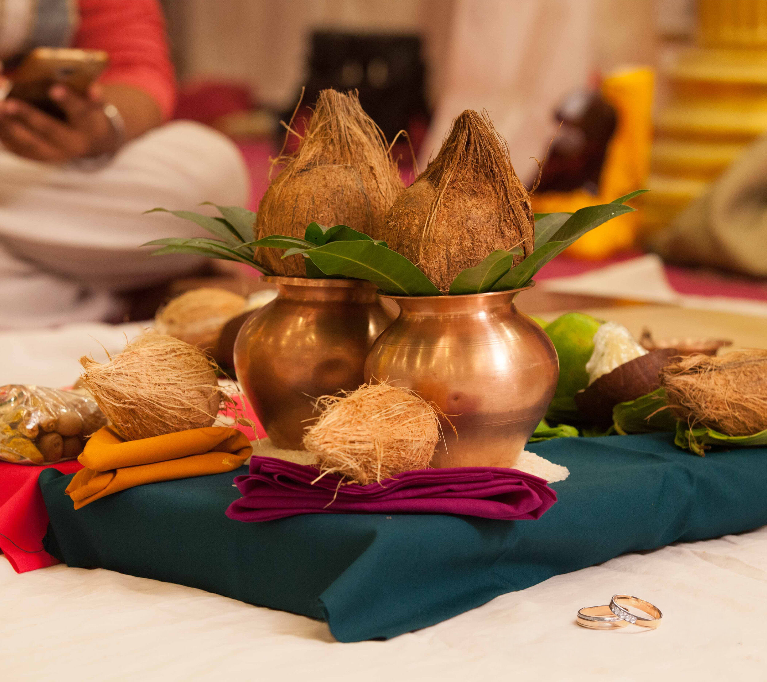 A brass traditional pot and a nariyal in it for indian wediing rituals